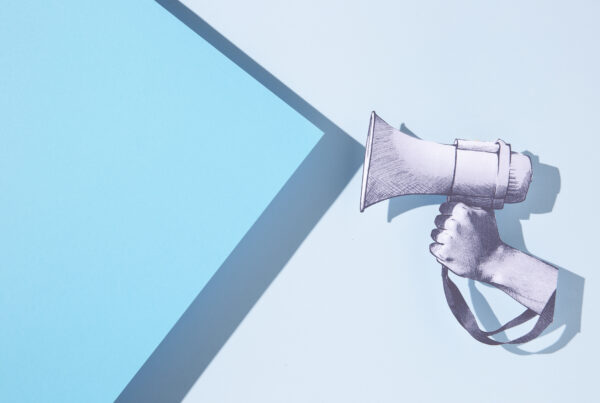 paper hand holding megaphone
